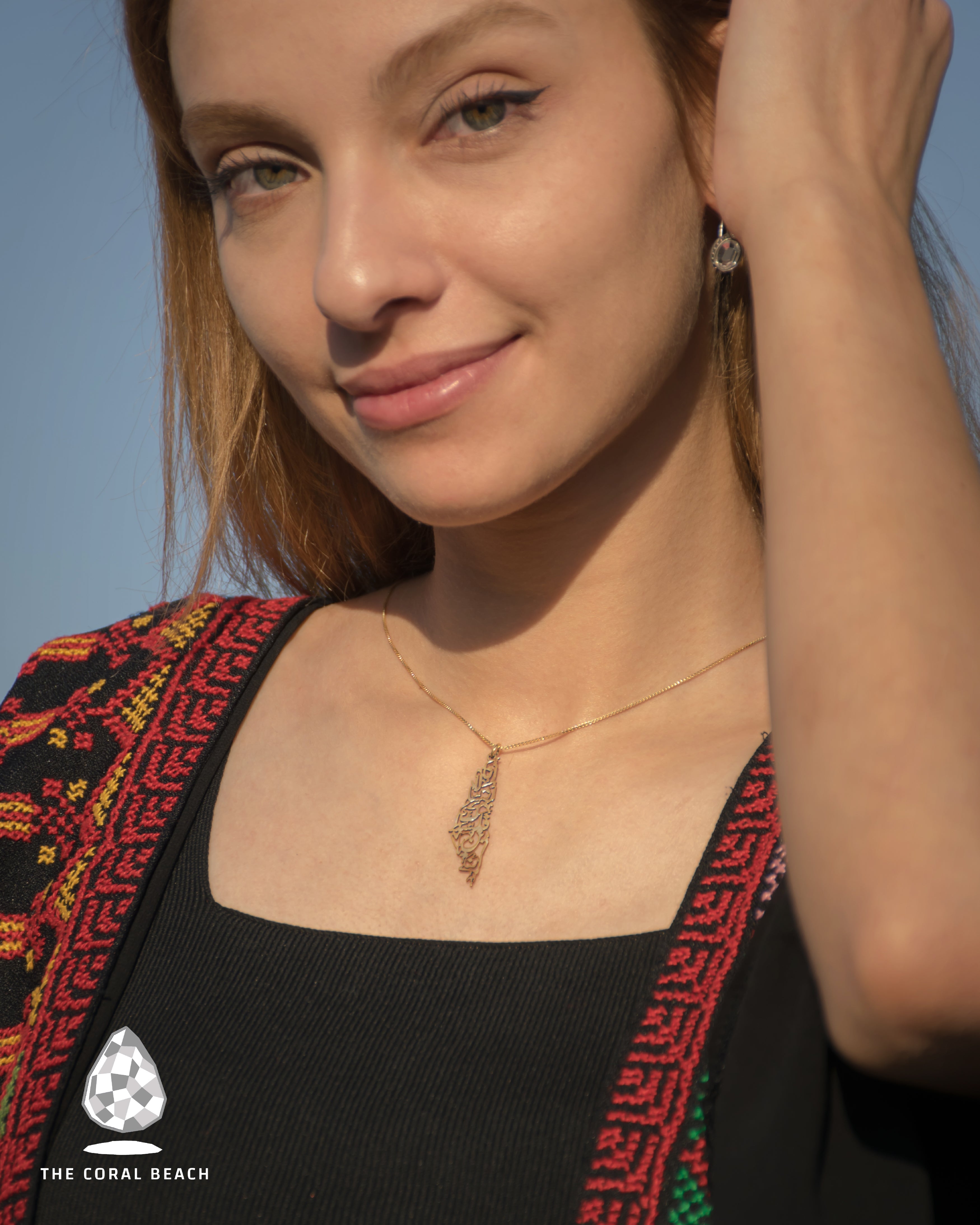 Palestine map with Palestinian famous song written inside necklace